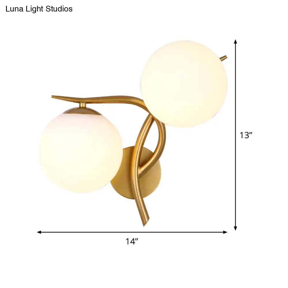 Gold orb wall sconce by Decorbites with dual frosted glass spheres and curved brass arms on Tampa Home & Garden Store