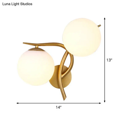 Gold orb wall sconce by Decorbites with dual frosted glass spheres and curved brass arms on Tampa Home & Garden Store