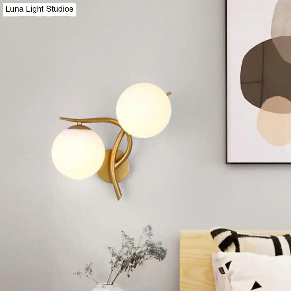 Gold orb wall sconce with two frosted glass globes and brass arms Decorbites on Tampa Home & Garden Store