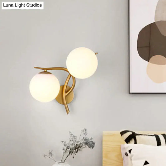 Gold orb wall sconce with two frosted glass globes and brass arms Decorbites on Tampa Home & Garden Store
