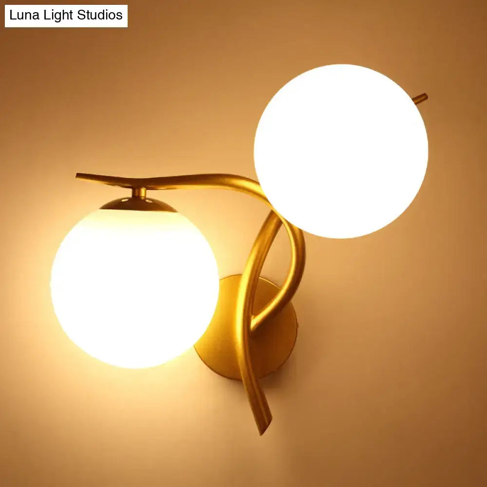 Gold Orb Wall Sconce by Decorbites with dual frosted glass globes and curved gold arms on Tampa Home & Garden Store