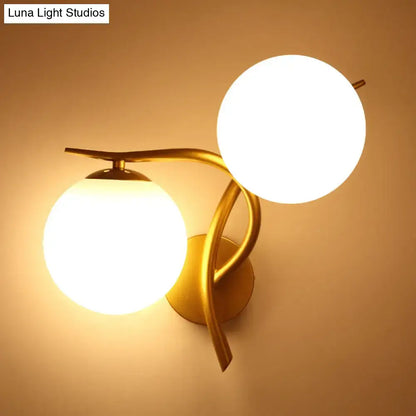Gold Orb Wall Sconce by Decorbites with dual frosted glass globes and curved gold arms on Tampa Home & Garden Store