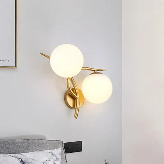 Gold orb wall sconce with twin frosted glass globes on brass mount Decorbites on Tampa Home & Garden Store