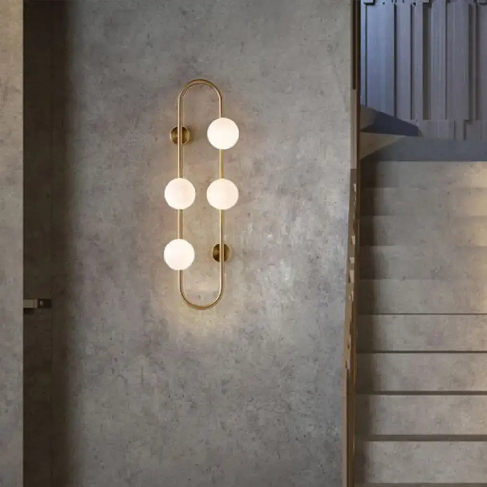 Gold milky glass wall sconce with four globe bulbs on an oval brass frame Decorbites on Tampa Home & Garden Store
