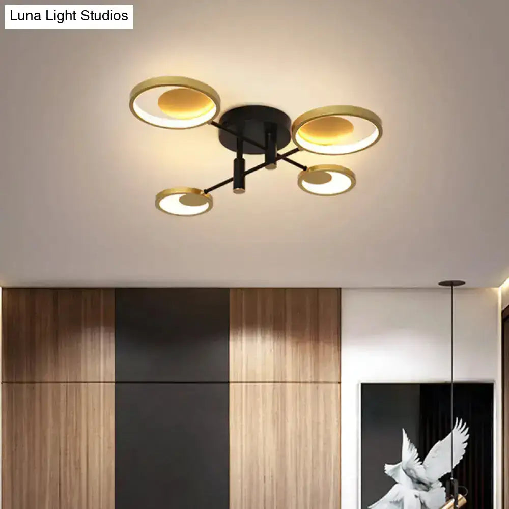 Gold Molecule Ceiling Chandelier with five circular gold rings and a black mount on Tampa Home & Garden Store