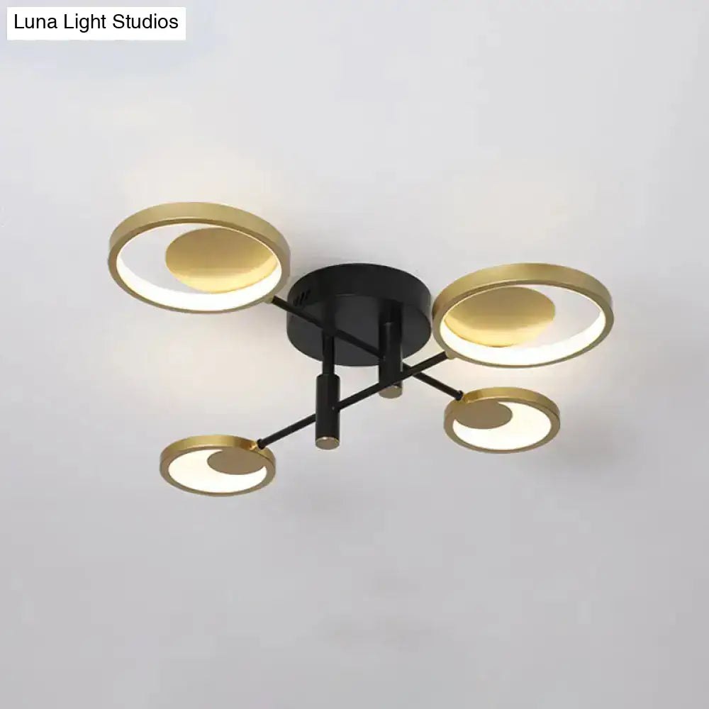 Gold Molecule Ceiling Chandelier with four gold rings on a black hub by Decorbites on Tampa Home & Garden Store