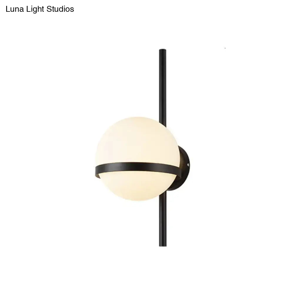 Gold opal glass wall sconce with black metal band and vertical mounting rod on Tampa Home & Garden Store