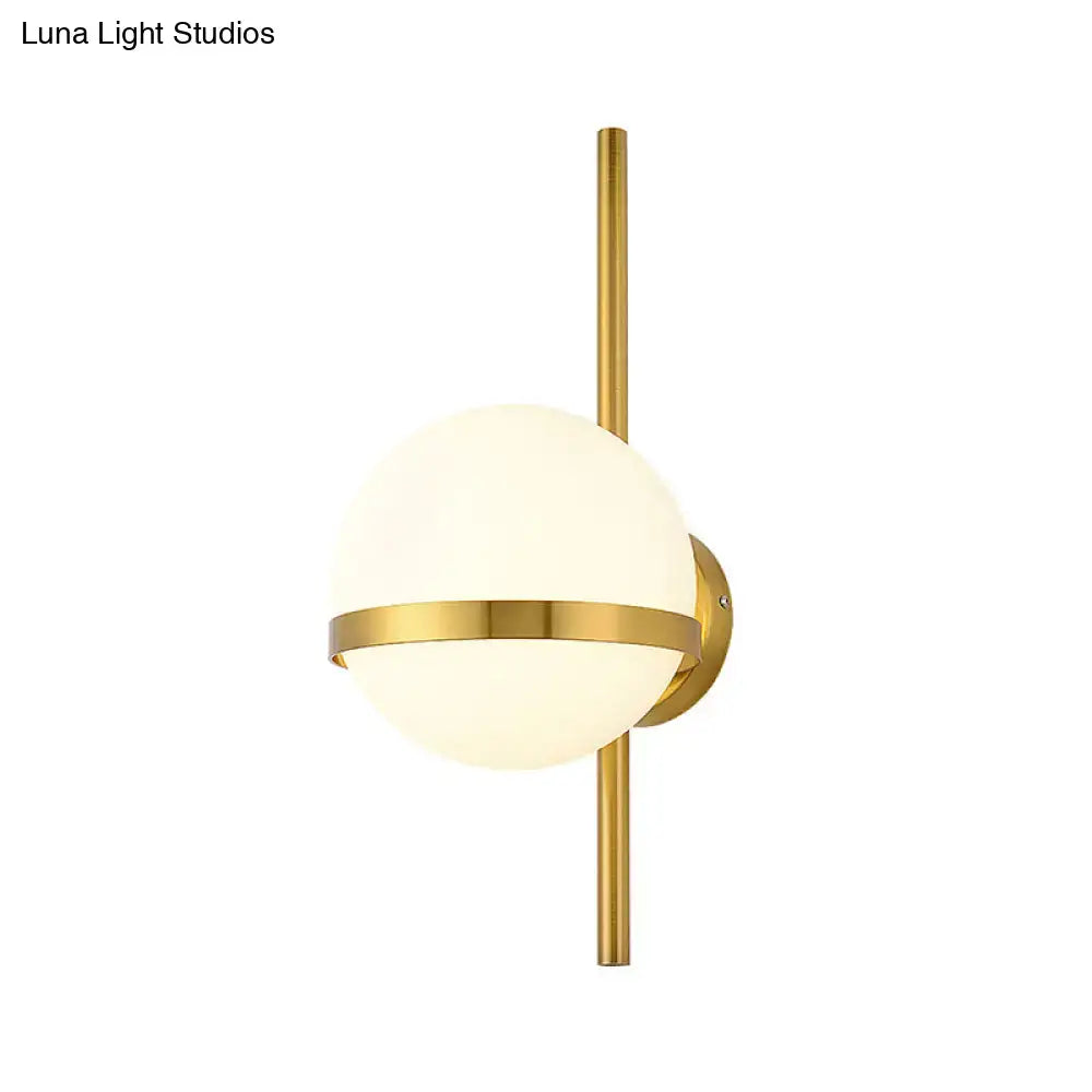 Gold opal glass wall sconce by Decorbites with a gold rod and circular wall mount on Tampa Home & Garden Store