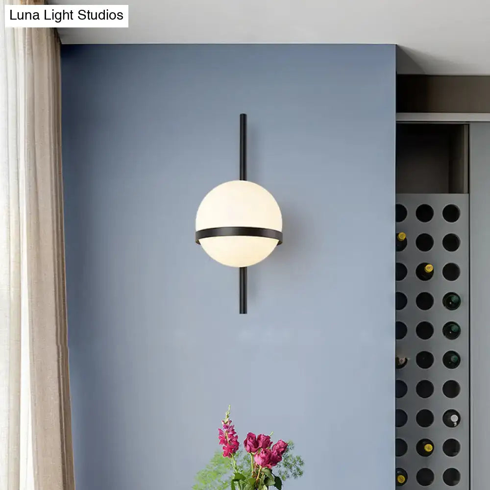 Gold opal glass wall sconce by Decorbites, spherical white globe with black band, wall mounted on Tampa Home & Garden Store