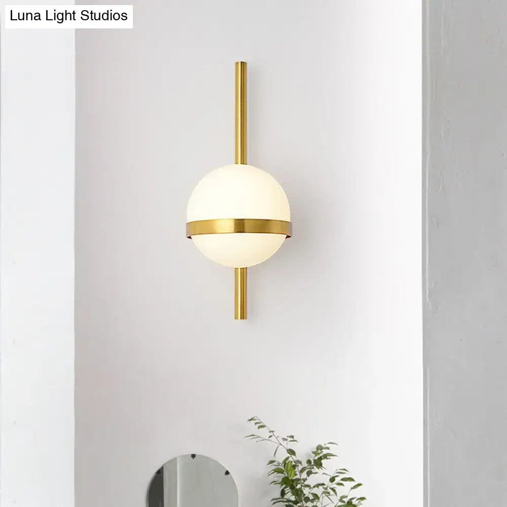 Gold opal glass wall sconce with brass vertical mount and globe by Decorbites on Tampa Home & Garden Store