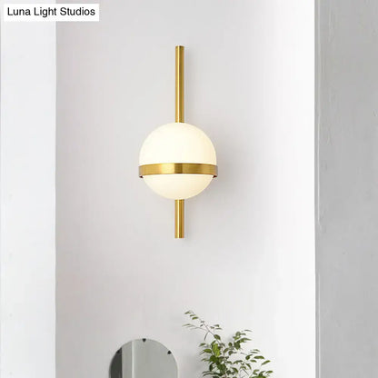 Gold opal glass wall sconce with brass vertical mount and globe by Decorbites on Tampa Home & Garden Store