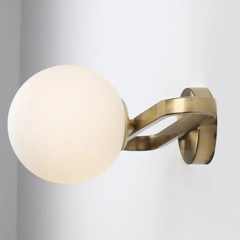 Gold opal glass sphere wall lamp with brass finish by Decorbites, wall-mounted on Tampa Home & Garden Store