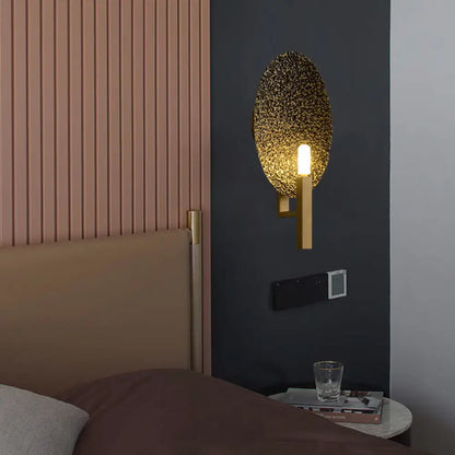 Gold Metal Speckled Glass Sconce by Decorbites with brass arm on dark wall on Tampa Home & Garden Store