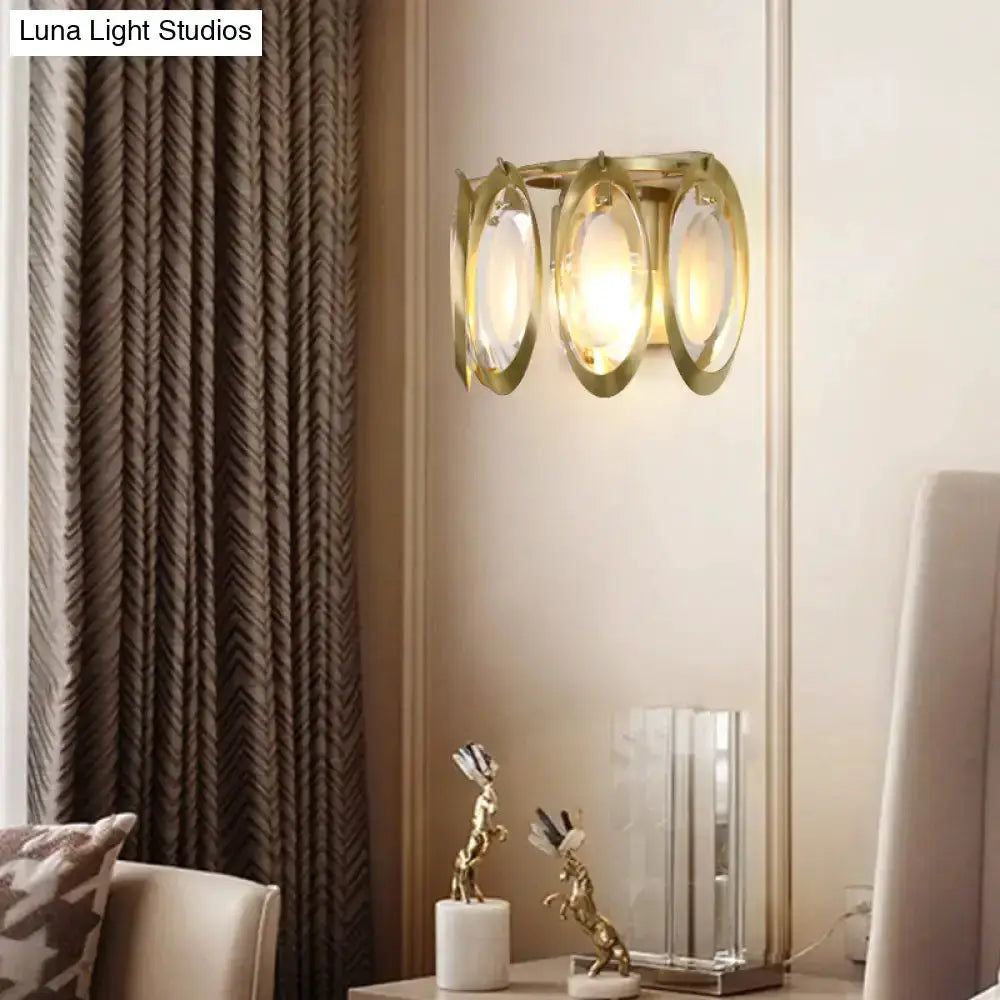 Modern gold oval sconce light with glass panels mounted on living room wall on Tampa Home & Garden Store