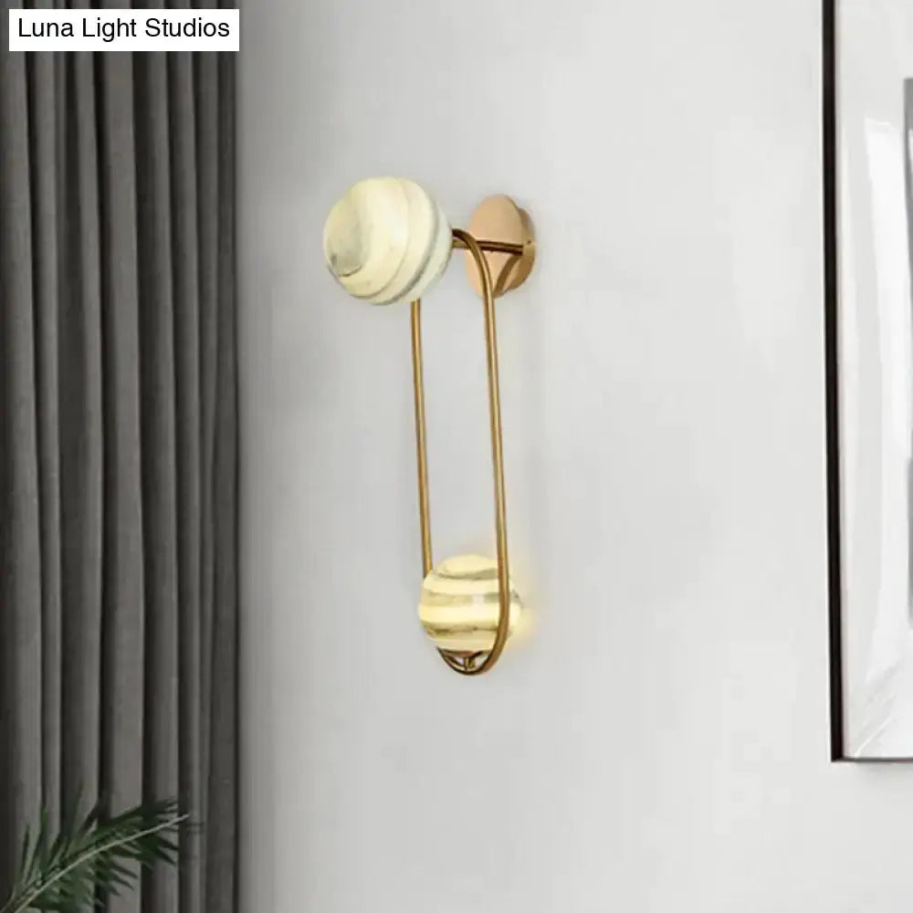 Modern gold oval wall sconce with marble shades by Decorbites for living room on Tampa Home & Garden Store