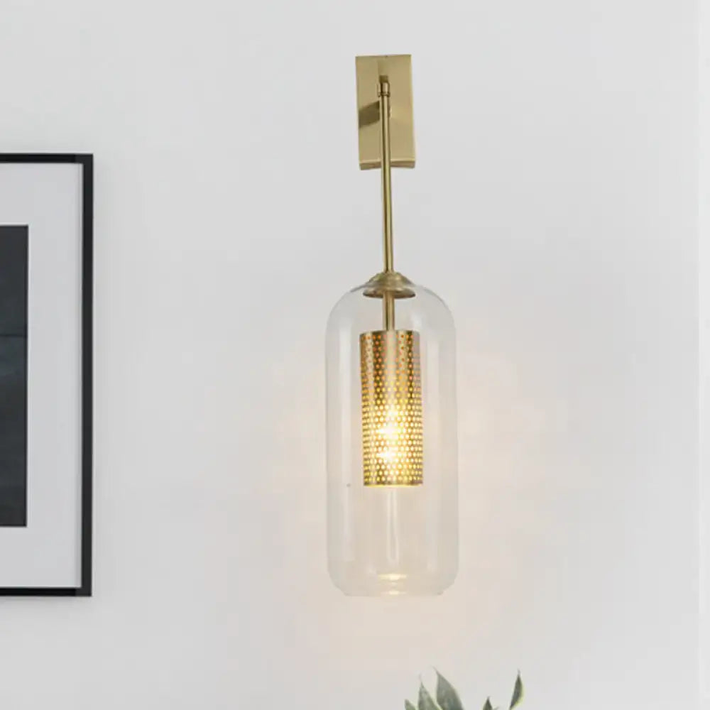 Gold glass bedroom wall sconce with cylindrical shade and perforated brass module on Tampa Home & Garden Store