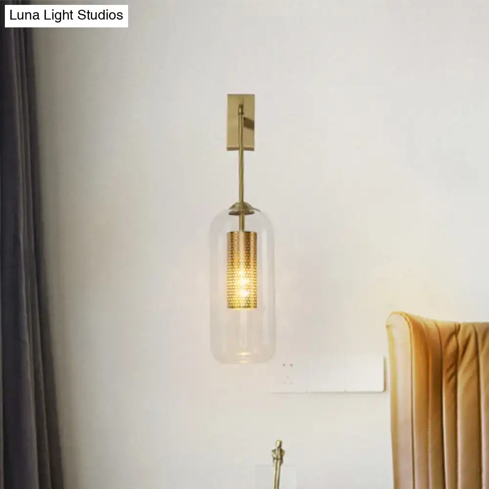 Gold glass bedroom wall sconce with brass tubular inner core on Tampa Home & Garden Store