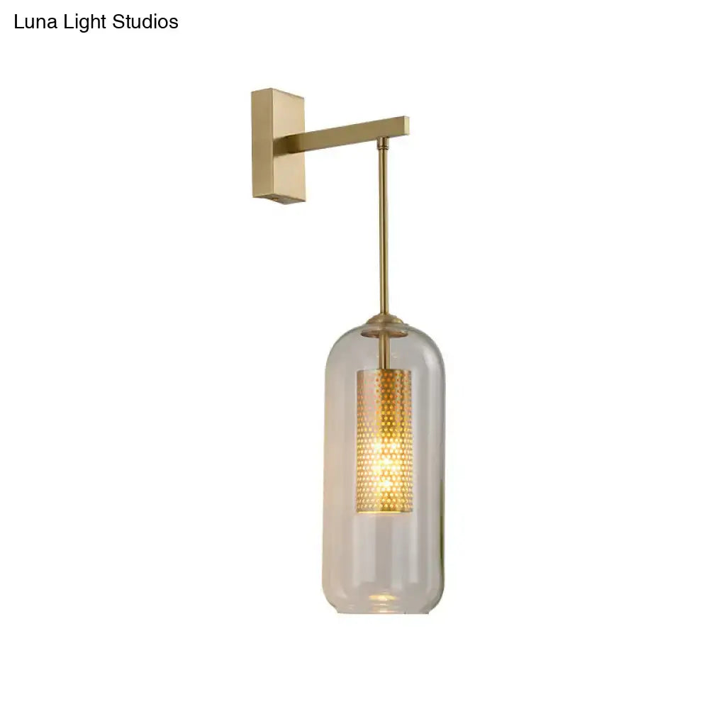 Gold glass bedroom wall sconce with brass finish and clear cylindrical shade by Decorbites on Tampa Home & Garden Store