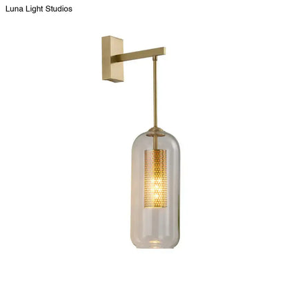 Gold glass bedroom wall sconce with brass finish and clear cylindrical shade by Decorbites on Tampa Home & Garden Store
