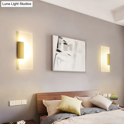 Gold acrylic wall sconce pair with warm LED glow on gray wall beside bed on Tampa Home & Garden Store