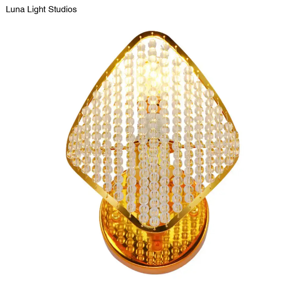 Gold clear crystal wall light fixture with a diamond-shaped gold frame and hanging beads on Tampa Home & Garden Store