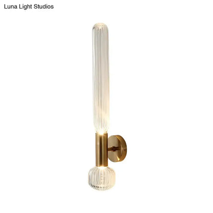 Modern gold ribbed glass wall sconce with vertical glass tube and brass backplate Decorbites on Tampa Home & Garden Store