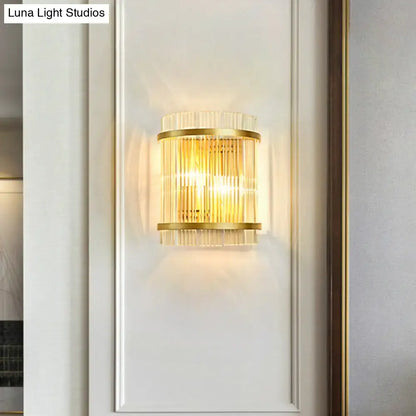 Gold ribbed glass wall sconce with brass bands mounted on a white wall on Tampa Home & Garden Store