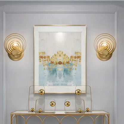 Decorbites modern gold ripple glass wall light pair flanks a framed artwork on Tampa Home & Garden Store