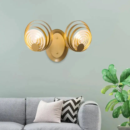 Modern gold ripple glass wall light fixture with dual spiral shades and gold backplate on Tampa Home & Garden Store
