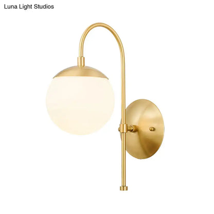 Gold Opal Glass Wall Lamp brass wall sconce with curved arm and frosted glass globe on Tampa Home & Garden Store