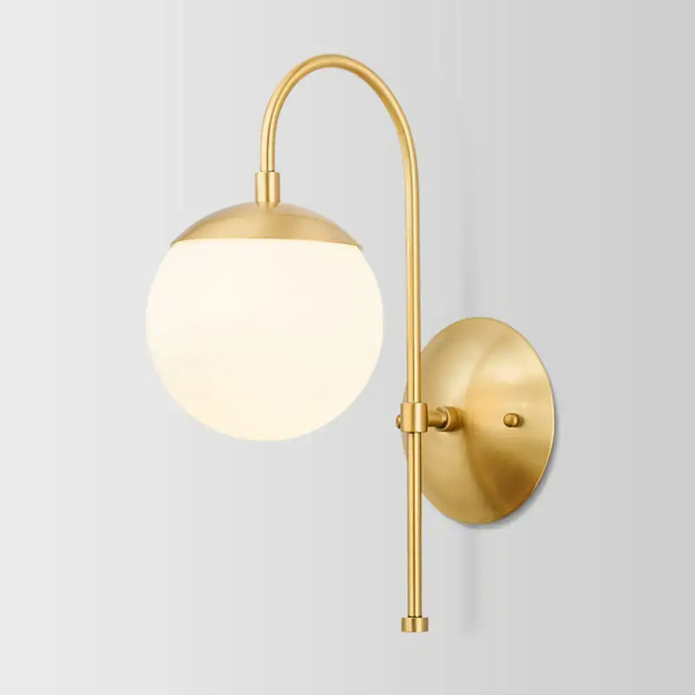 Decorbites Gold Opal Glass Wall Lamp with curved brass arm and frosted globe on Tampa Home & Garden Store