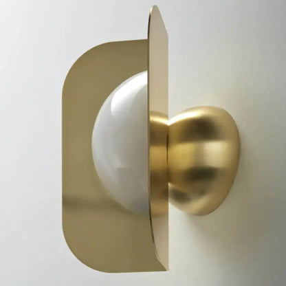 Gold curved metal sconce with white glass globe wall mount on Tampa Home & Garden Store