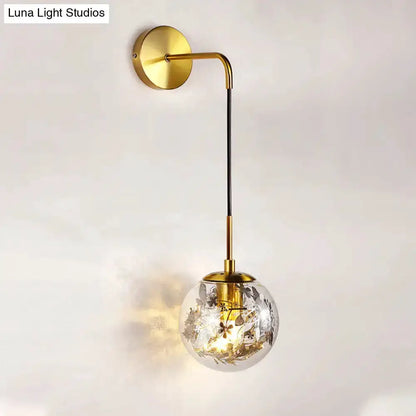 Modern gold shattered-leaf clear glass globe sconce with brass arm for bedroom lighting on Tampa Home & Garden Store