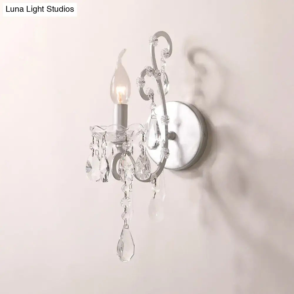 Crystal Drop Wall Sconce with clear crystal prisms and curved metal frame, wall-mounted on Tampa Home & Garden Store