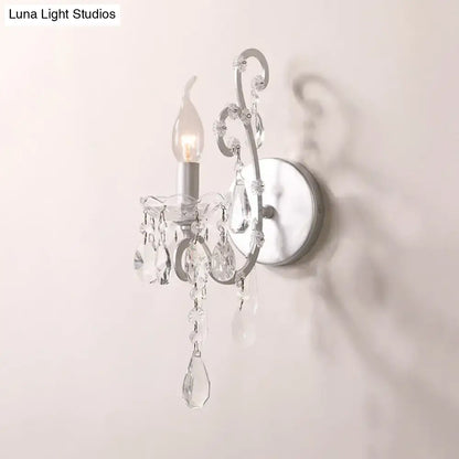Crystal Drop Wall Sconce with clear crystal prisms and curved metal frame, wall-mounted on Tampa Home & Garden Store