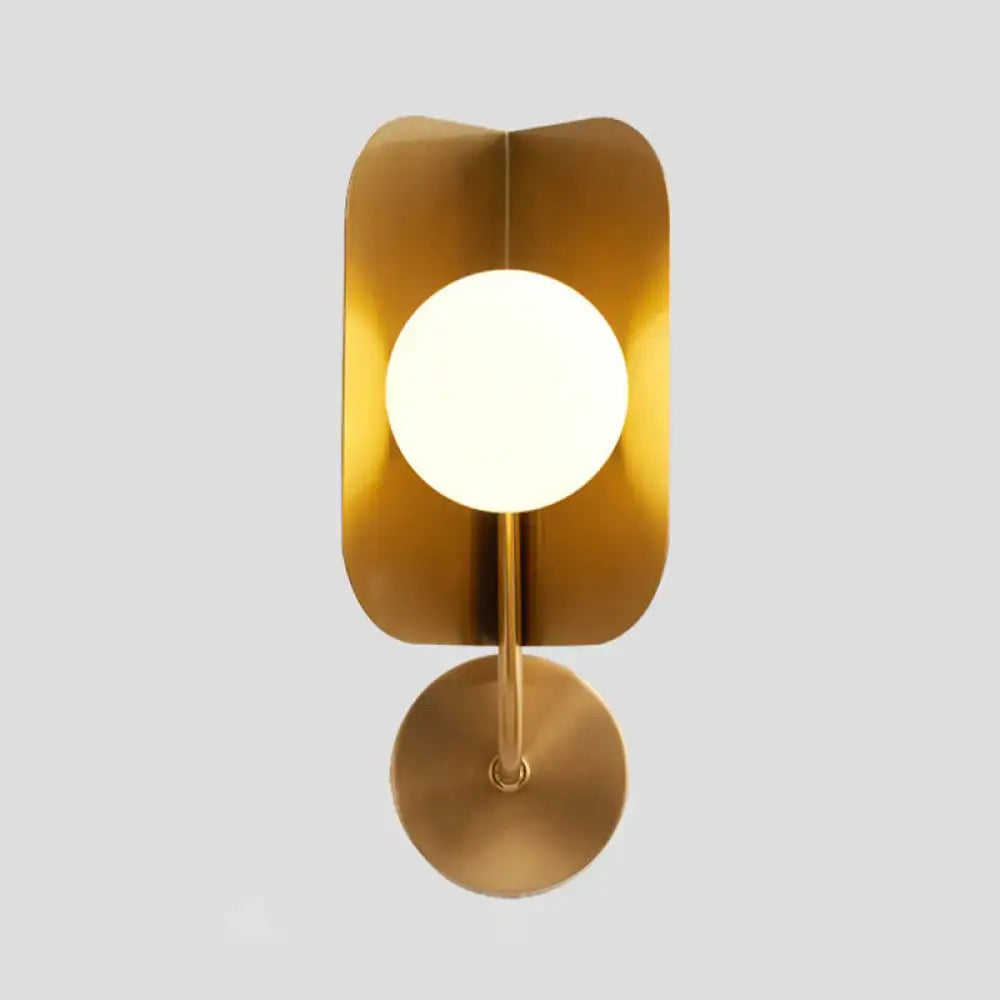 Gold sphere metal wall sconce by Decorbites with frosted globe and rounded backplate on Tampa Home & Garden Store