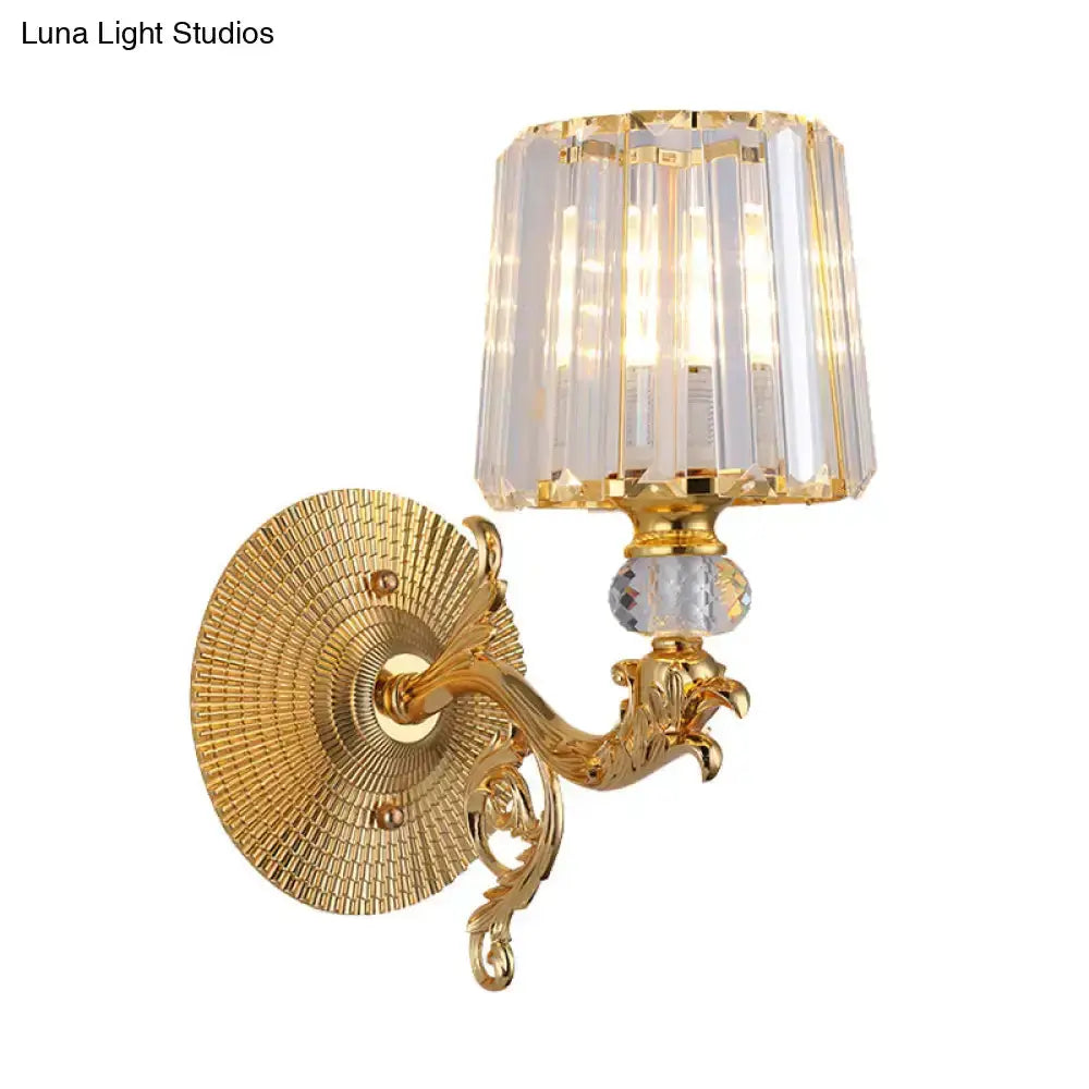 Modern gold tapered wall sconce with crystal shade and dragon-inspired ornate backplate on Tampa Home & Garden Store