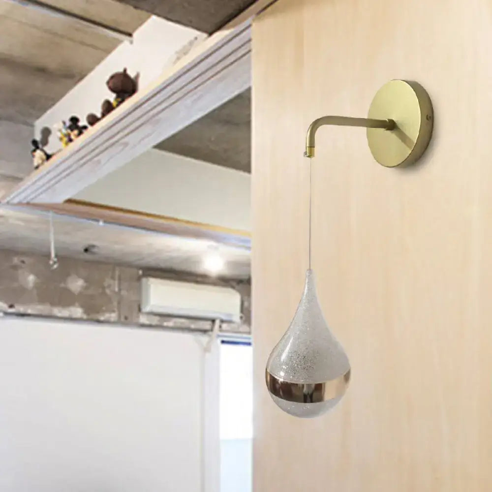 Gold teardrop wall sconce with frosted glass pendant and metallic band on wood wall on Tampa Home & Garden Store