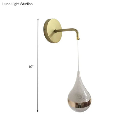 Gold teardrop wall sconce with brass arm and frosted glass shade by Decorbites on Tampa Home & Garden Store