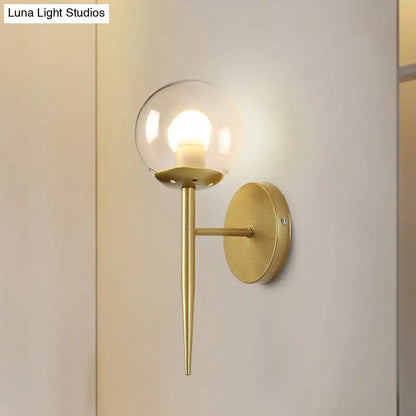 Decorbites gold glass torch sconce, wall-mounted fixture with clear globe and brass finish on Tampa Home & Garden Store