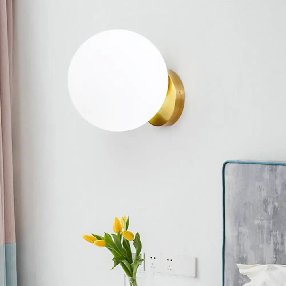 Decorbites gold opal glass wall lamp with round white globe and brass mount on Tampa Home & Garden Store