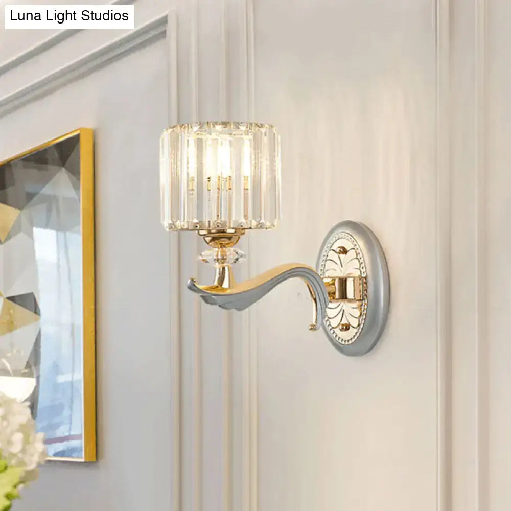 Decorbites gold crystal cylinder wall sconce with clear ribbed shade and ornate backplate on Tampa Home & Garden Store