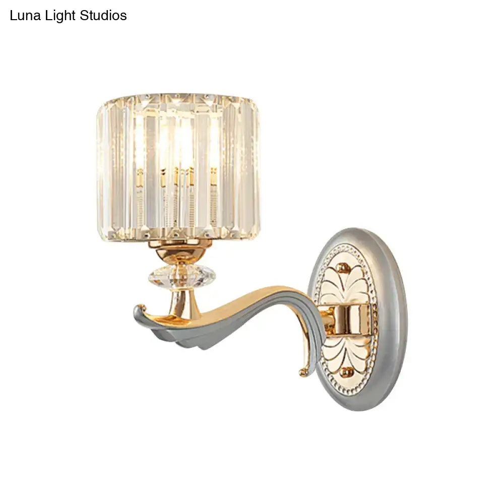 Decorbites gold crystal cylinder wall sconce with curved arm and decorative backplate on Tampa Home & Garden Store