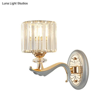 Decorbites gold crystal cylinder wall sconce with curved arm and decorative backplate on Tampa Home & Garden Store