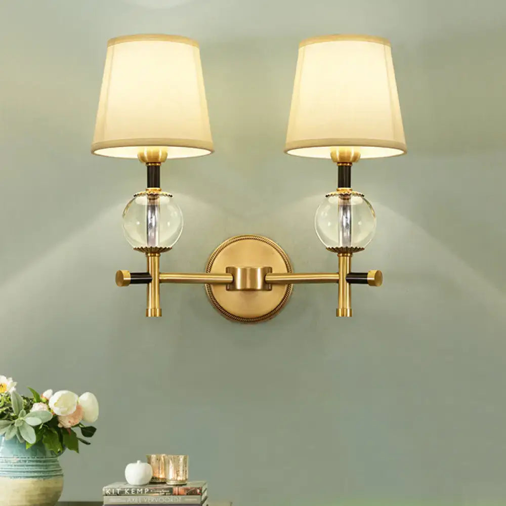 Gold brass two-light sconce with fabric shades and crystal glass orbs by Decorbites on Tampa Home & Garden Store