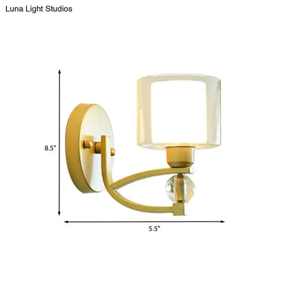 Gold dual glass wall sconce with curved brass arm and glass shade on Tampa Home & Garden Store