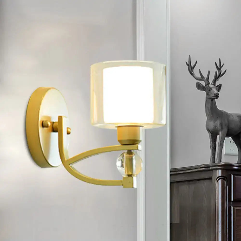 Gold dual glass wall sconce with a curved arm and square frosted glass shade on Tampa Home & Garden Store