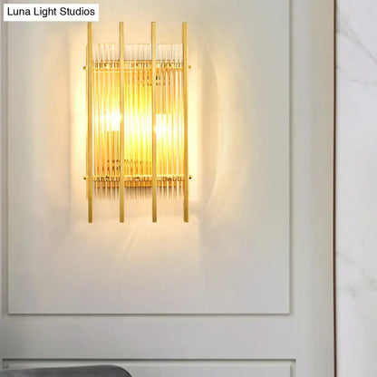Gold crystal dual-head rod sconce with vertical brass rods and warm glow on Tampa Home & Garden Store