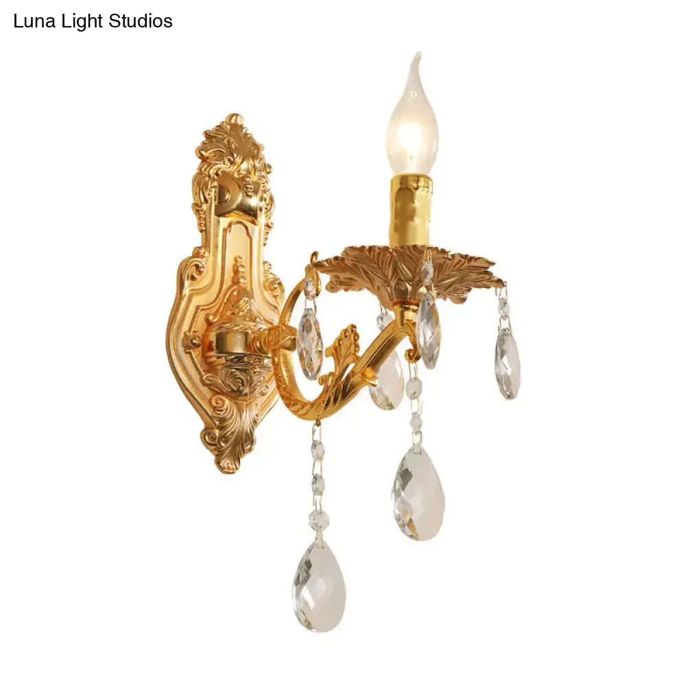 Gold crystal candelabra sconce, ornate leaf-accented wall mount with hanging crystal drops on Tampa Home & Garden Store