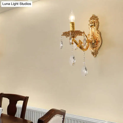 Gold crystal candelabra wall sconce with hanging prisms and ornate backplate Decorbites on Tampa Home & Garden Store